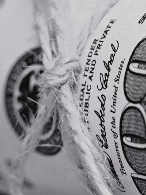 Close up on Money rolled and tied with string
